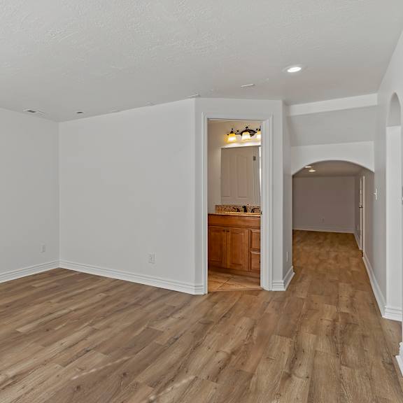 a room with wooden floors and white walls.
