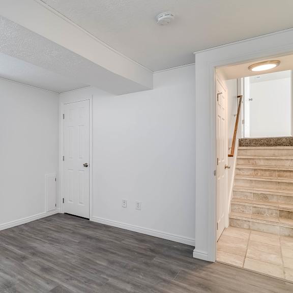 a room with a wooden floor and white walls.