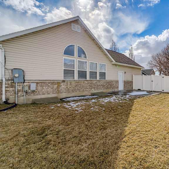 a backyard with a fence and a house