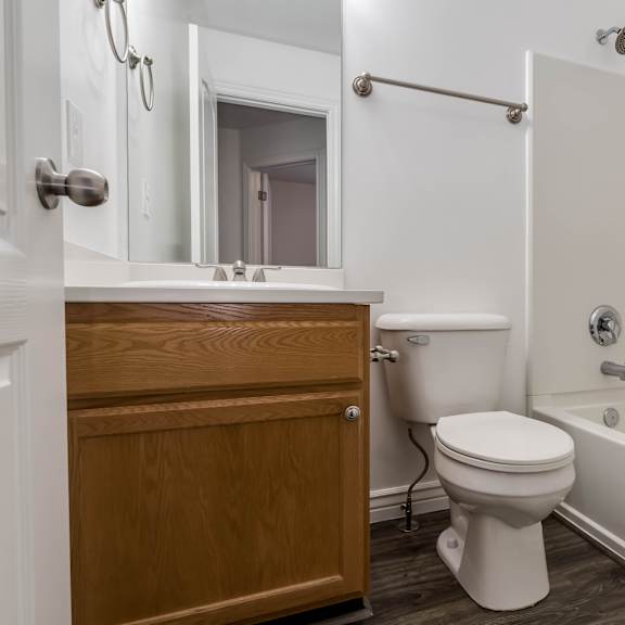 a bathroom with a toilet and a bath tub and a sink