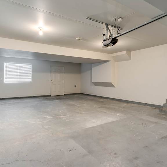 a large empty room with a concrete floor and white walls.