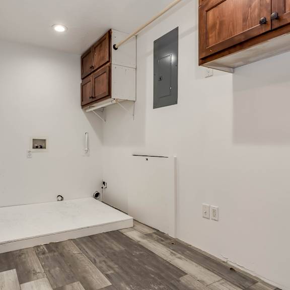 a room with a white wall and a wooden floor.