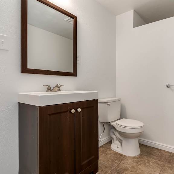 an empty bathroom with a toilet and a sink