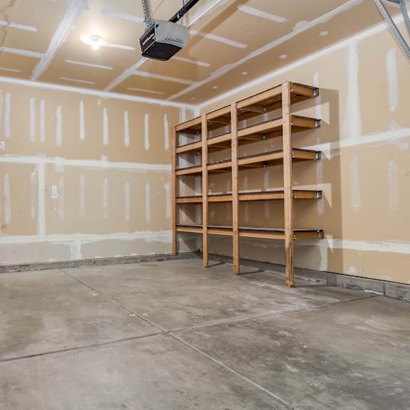 a room under construction with a door and shelving unit.