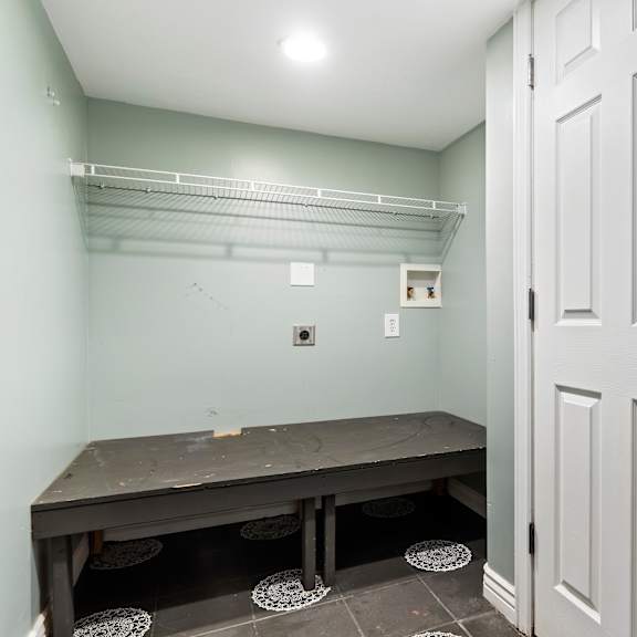 a room with a bench and a door.