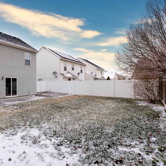 the back yard of a house with snow on the ground