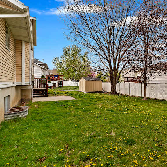 the backyard of a house with a yard and a fence