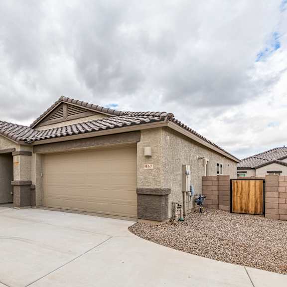a house with a grey roof and a brown garage door.