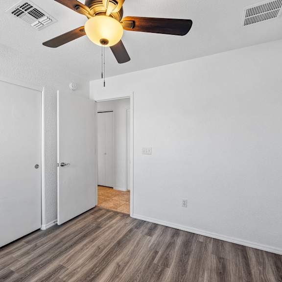 the living room of our two bedroom apartment atrium with a ceiling fan