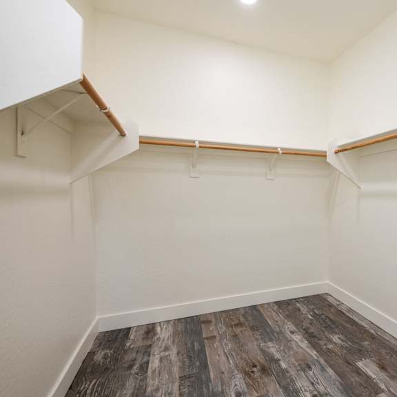 a room with a wooden floor and white walls.
