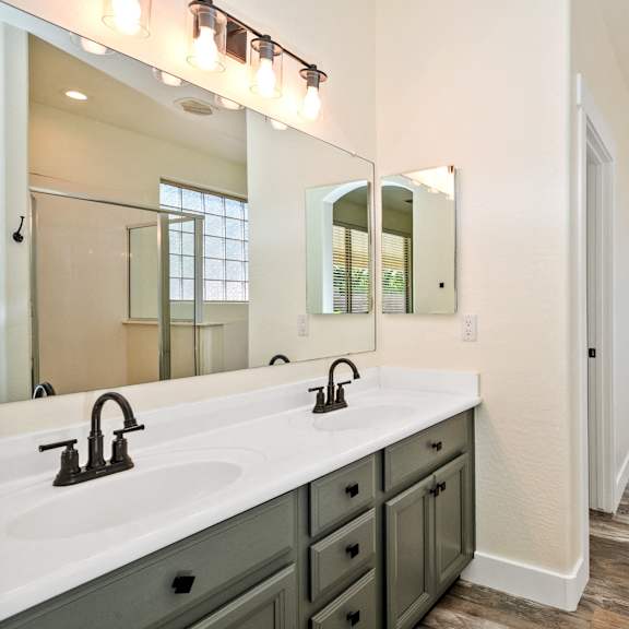 a bathroom with a vanity and a mirror.