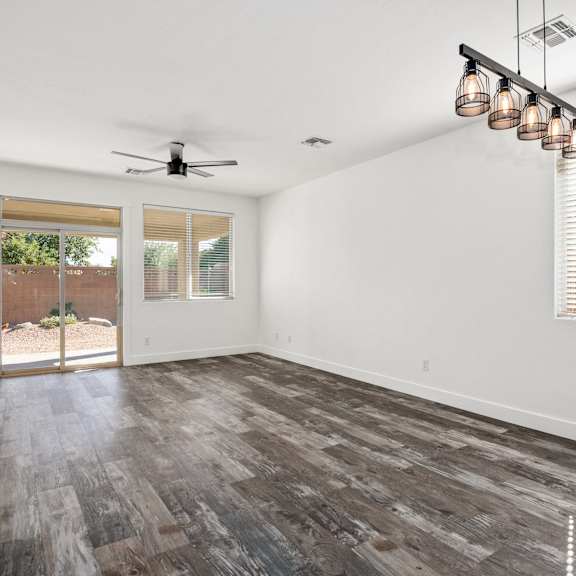 a room with a ceiling fan and a door leading outside.