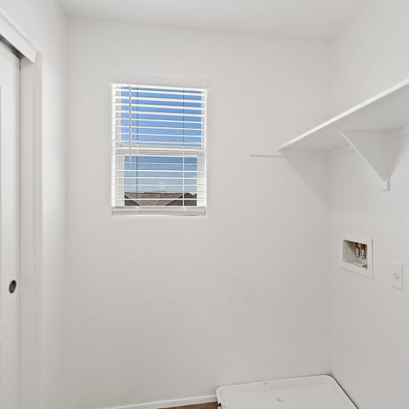 a white room with a window and a door.