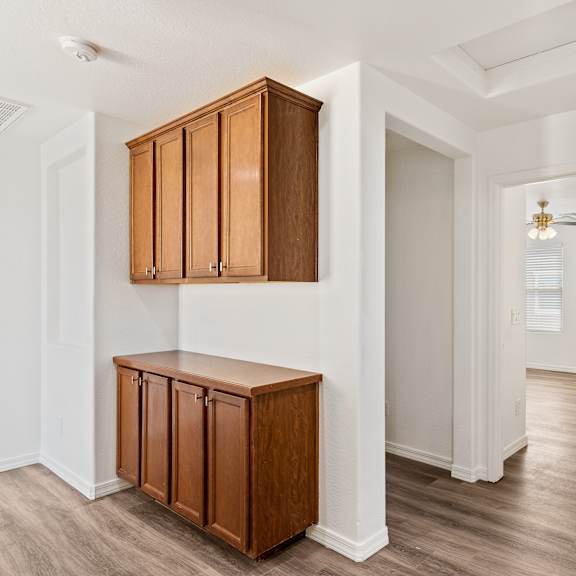 a room with a brown cabinet and a white door.