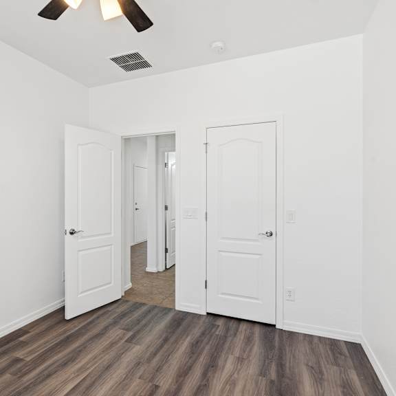 a room with white walls and a ceiling fan.