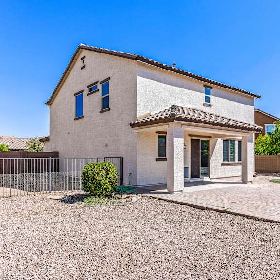 a house with a gravel driveway and a small garden.