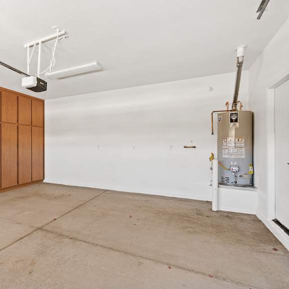 a room with a white wall and a brown cabinet.
