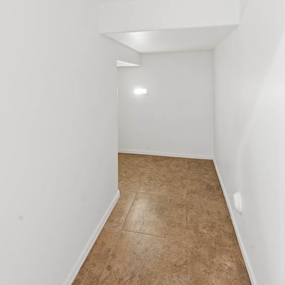 a long hallway with a light on the ceiling.