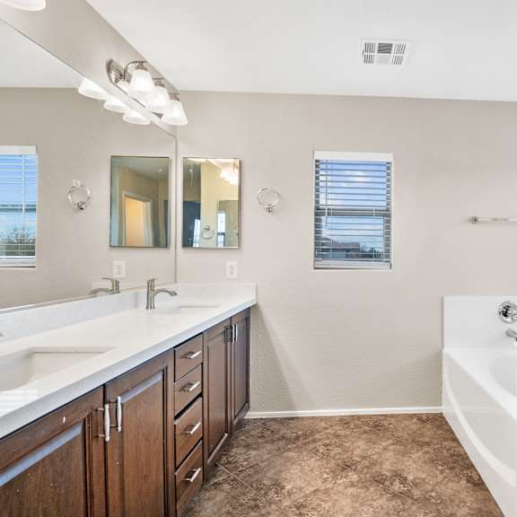 a bathroom with a white sink and a bathtub.