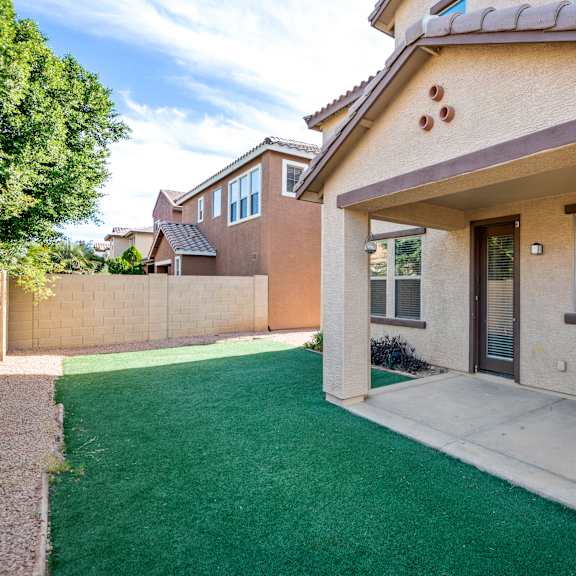 a house with a green lawn in front.