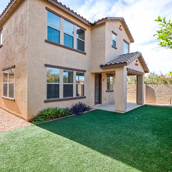a house with a green lawn in front.