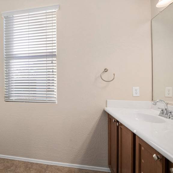 a bathroom with a sink and a bath tub and a window