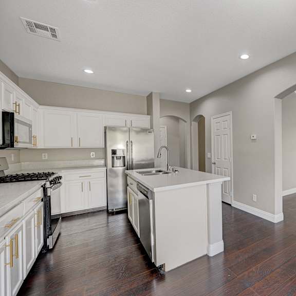 a kitchen with white cabinets and a white counter top