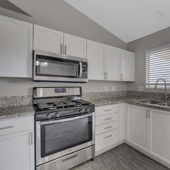 a kitchen with a stove, microwave, and dishwasher.