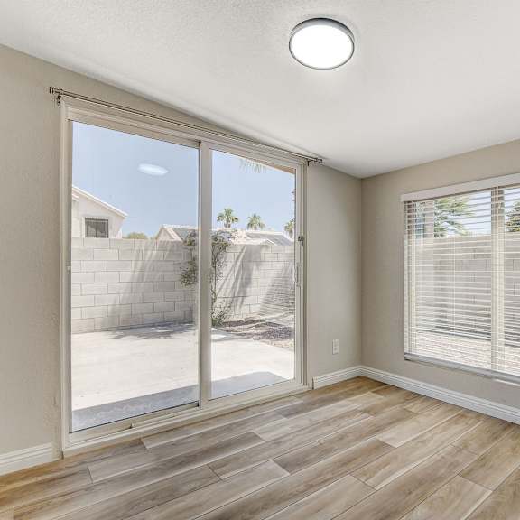 a sunny day outside through a sliding glass door.