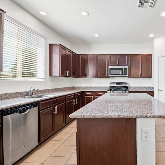 a kitchen with stainless steel appliances and granite counter tops