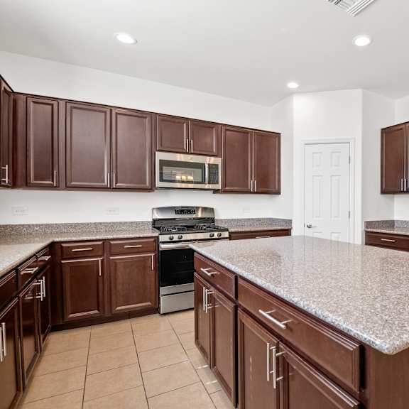 a kitchen with a granite counter top and stainless steel appliances