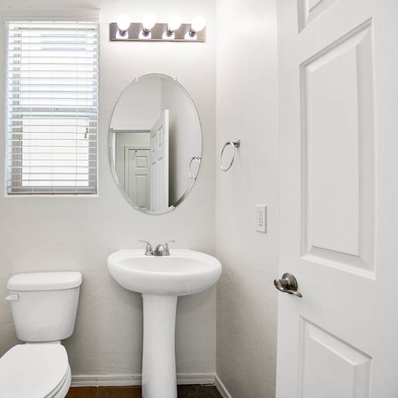 a bathroom with a sink and a toilet and a mirror
