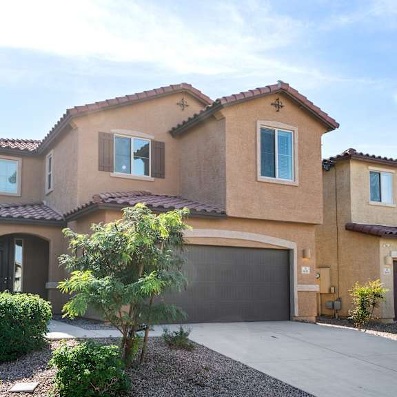 a house with a garage and a driveway in front of it