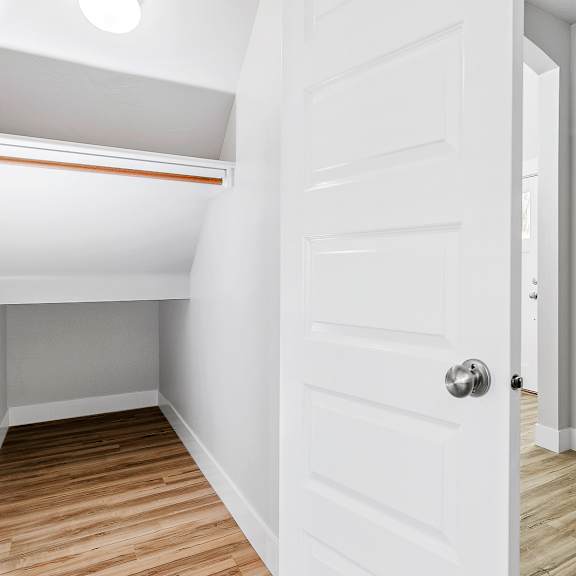 a white door with a silver handle is open.