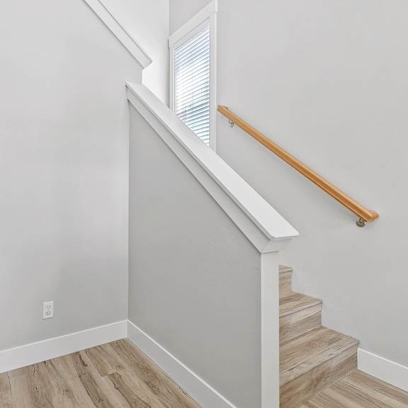 a staircase with a wooden handrail and steps.
