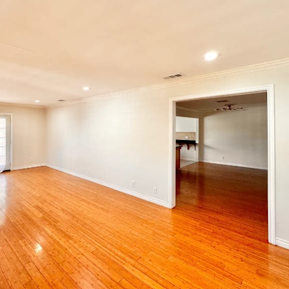a room with wooden floors and a sliding glass door.