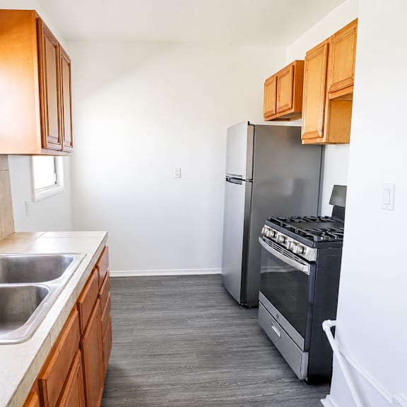 a kitchen with a stainless steel refrigerator and a stainless steel sink.