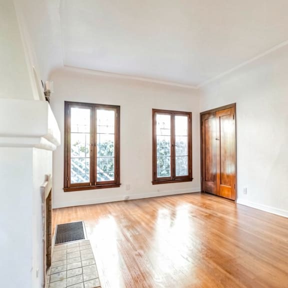 a room with wooden floors and white walls.