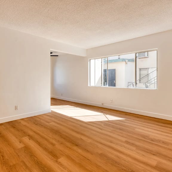a room with wooden floors and a window.