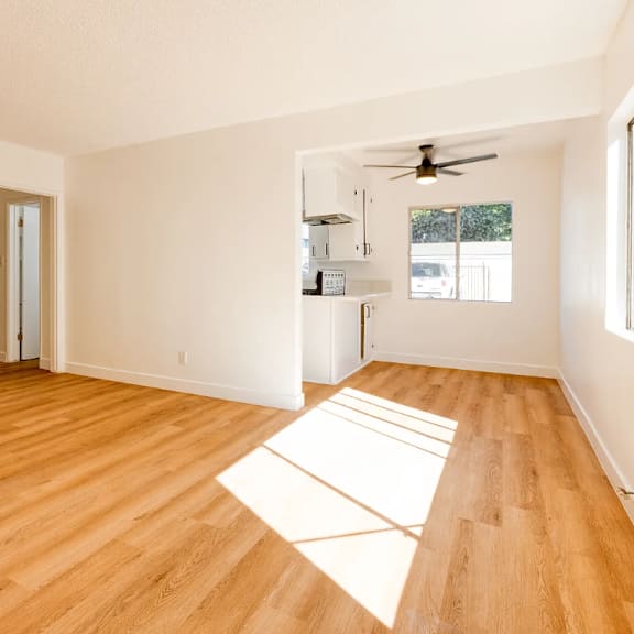 a room with wooden floors and white walls.
