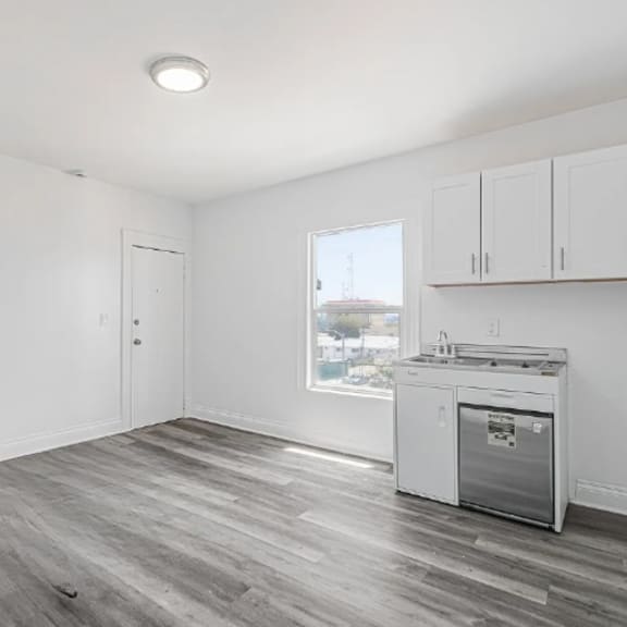 a kitchen area with a dishwasher and a window.
