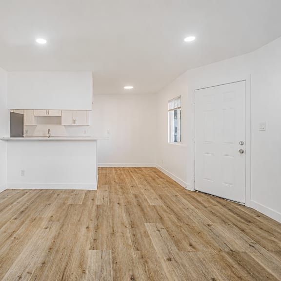 a room with wooden floors and white walls.