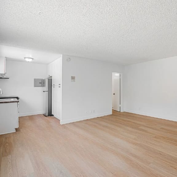 a room with wooden flooring and white walls.