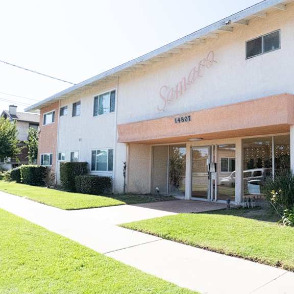a white building with a red sign that says "sunrise" on it.