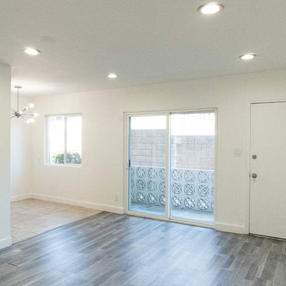 a room with a wooden floor and a white door.