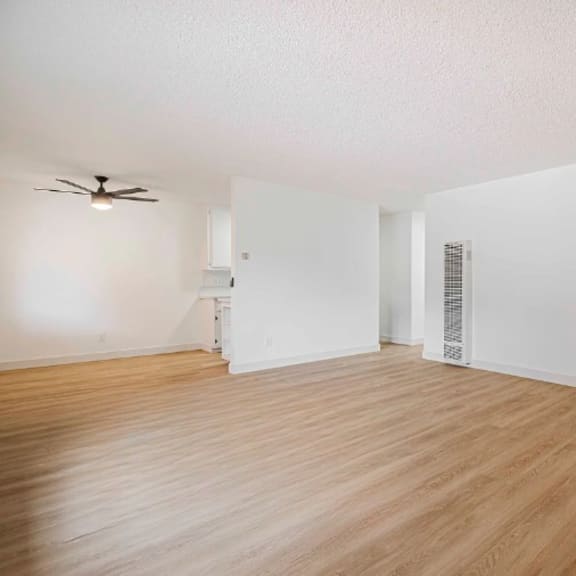 a room with wooden flooring and a ceiling fan.