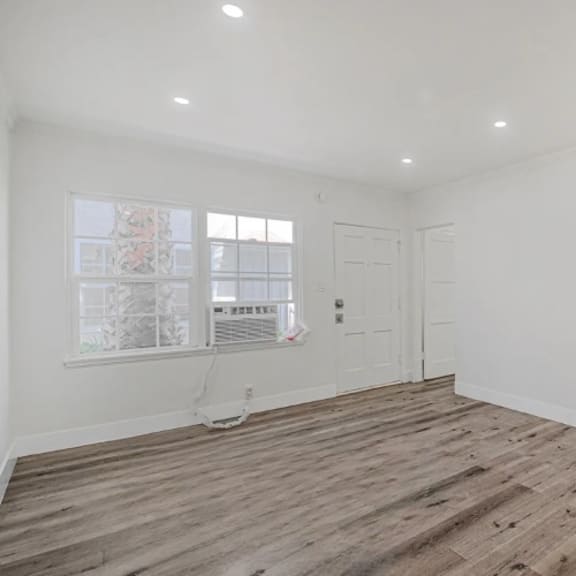 a room with wooden flooring and a window.