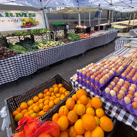 a market with a sign that says farms at the top.