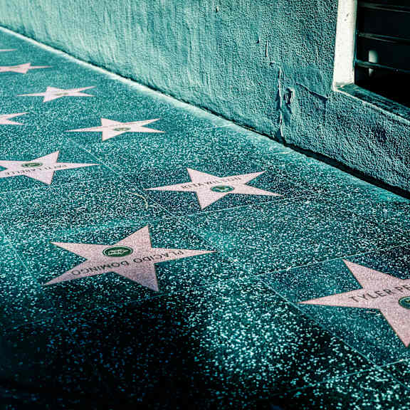 a sidewalk with white stars painted on it.