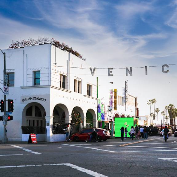 a street view of a city with the word "venice" written in the sky.